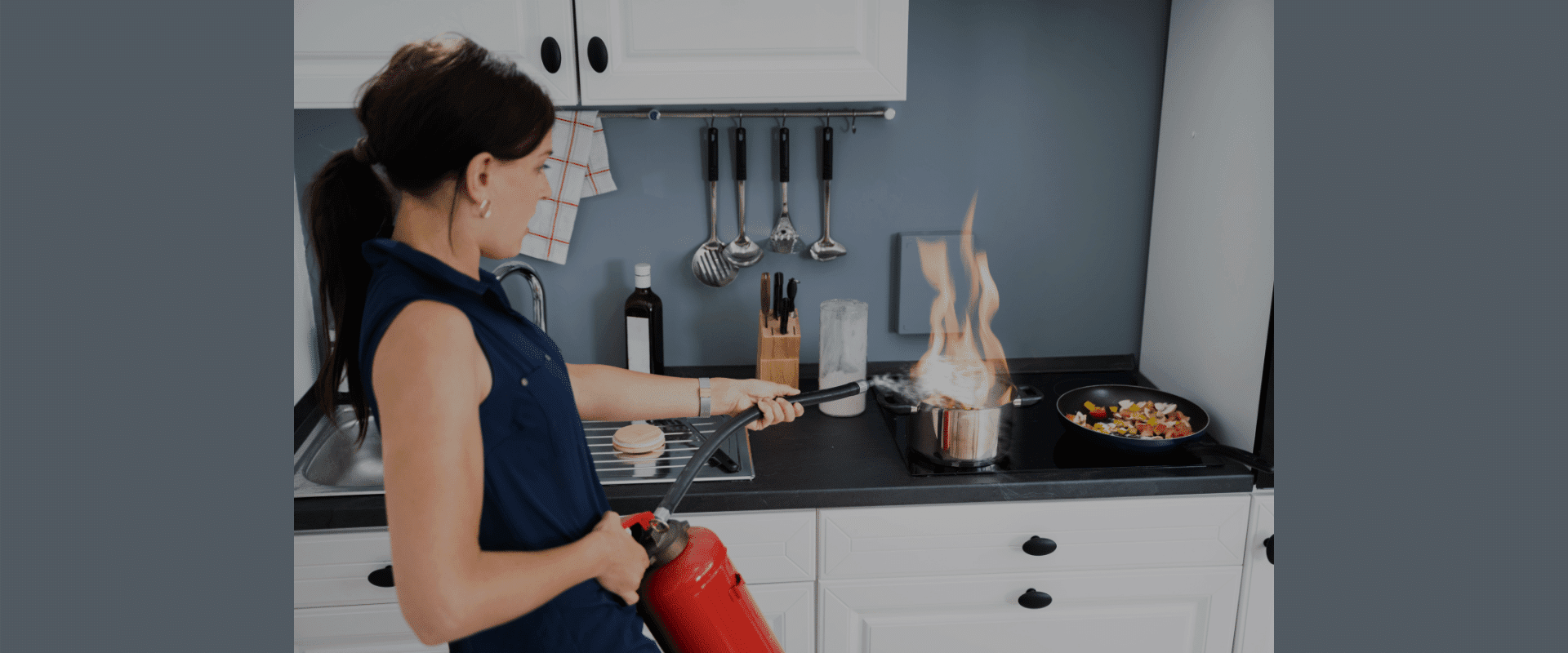 Woman extinguishing a pan fire