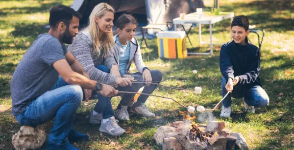Fire extinguisher for camping. best fire extinguishers for the home. family gathered around a camp fire